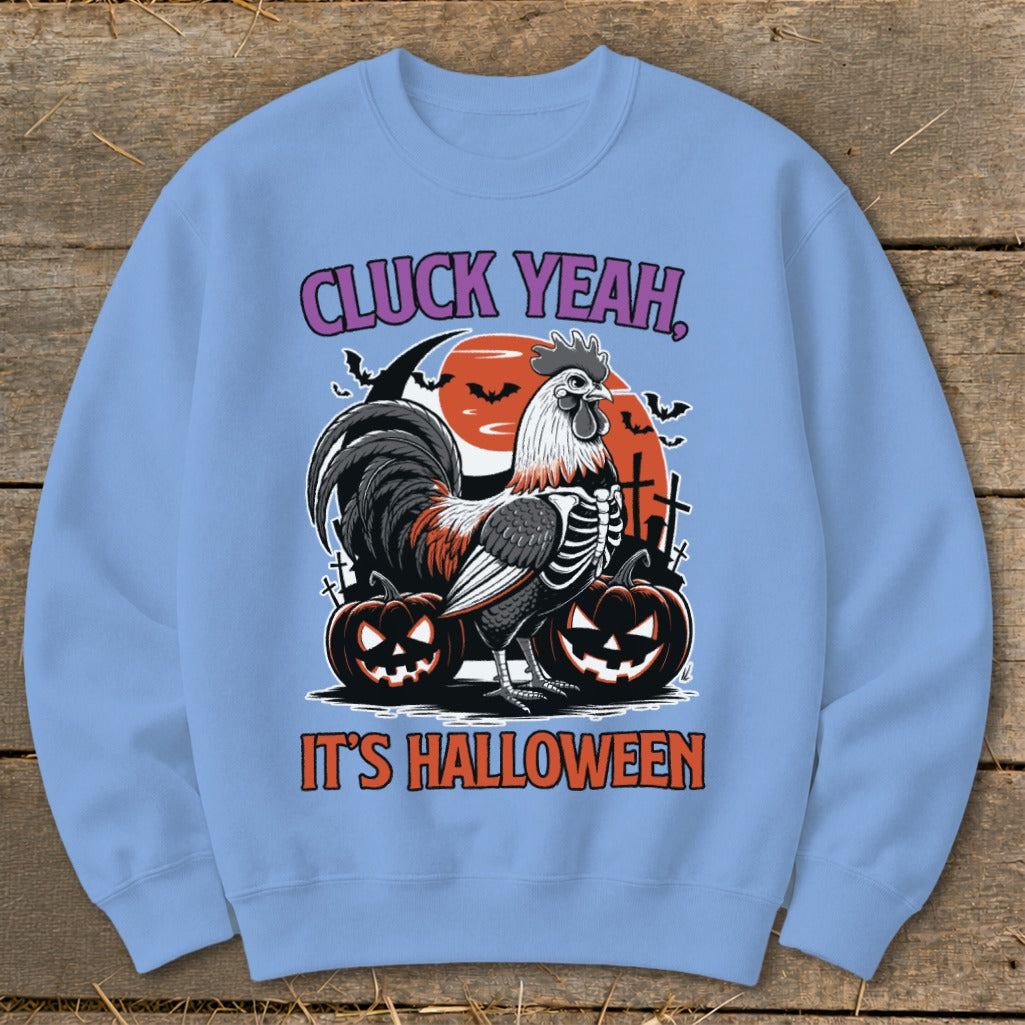 Light blue sweatshirt with Halloween graphics: rooster skeleton, pumpkins, bats, and text.