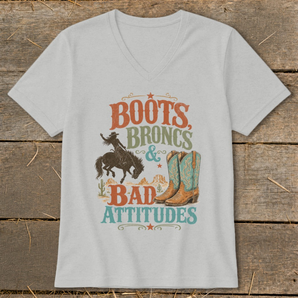T-shirt graphic with text "Boots, Broncs & Bad Attitudes" featuring a bronc rider and cowboy boots.