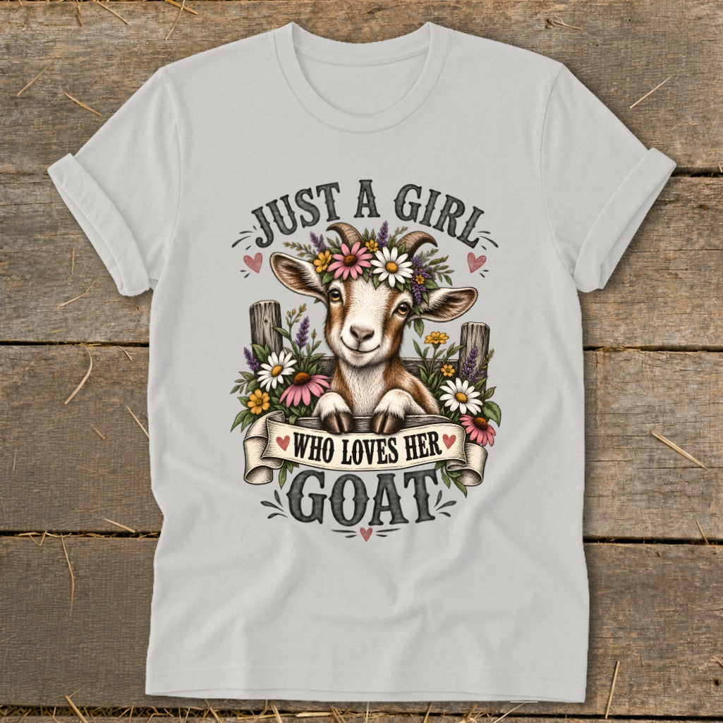 White t-shirt with a graphic of a goat wearing a flower crown and the text "Just a girl who loves her goat".