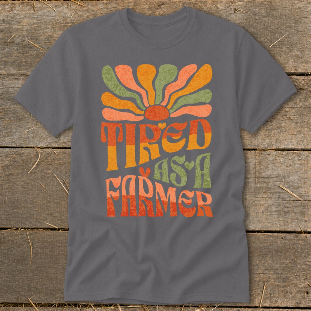 Grey t-shirt with "TIRED AS A FARMER" text and retro sun graphic.