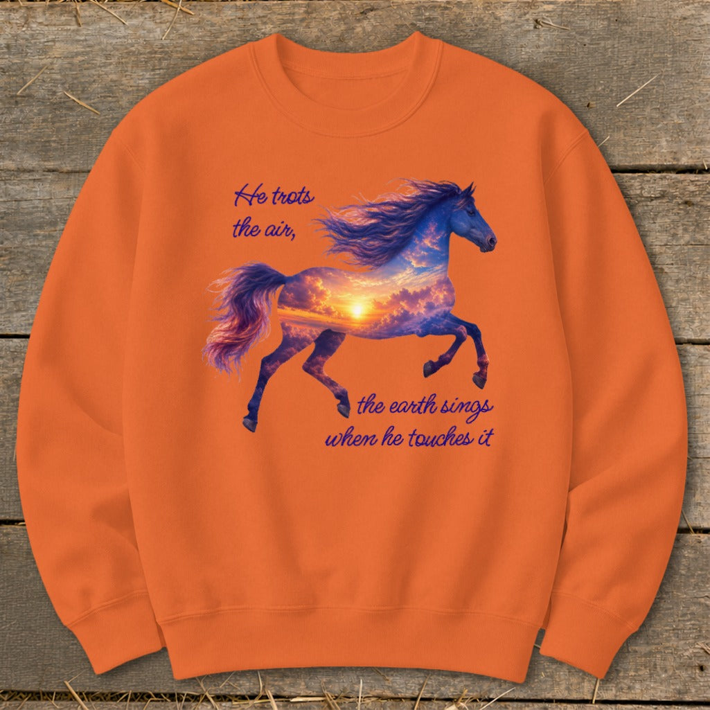 Orange crewneck sweatshirt featuring a galloping horse graphic filled with a sunset sky and inspirational text.