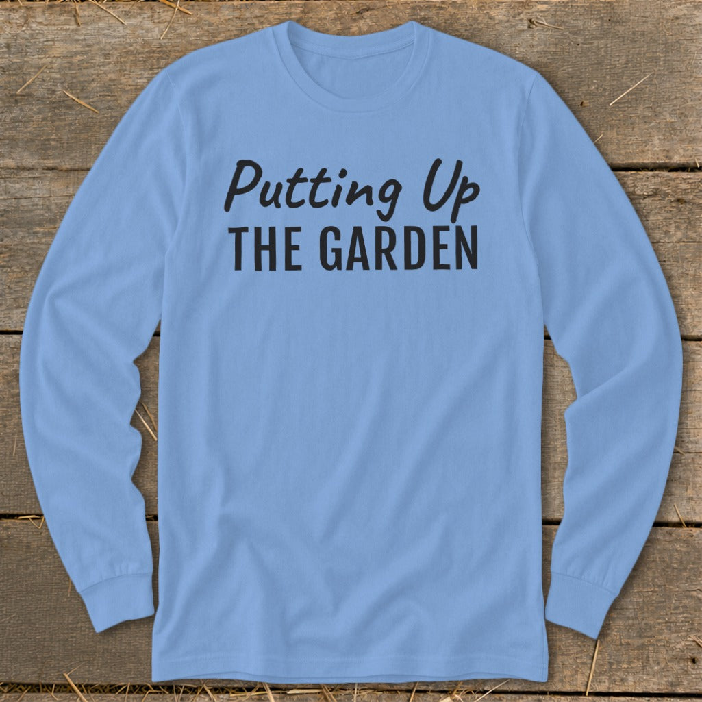 Light blue long-sleeve shirt with black text "Putting Up THE GARDEN."
