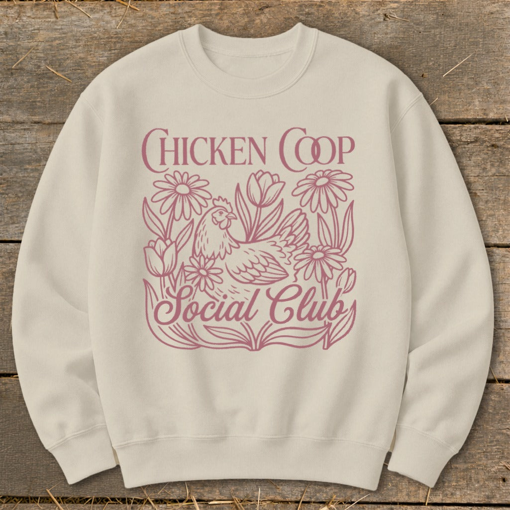 Cream sweatshirt with pink "Chicken Coop Social Club" text and chicken graphic.