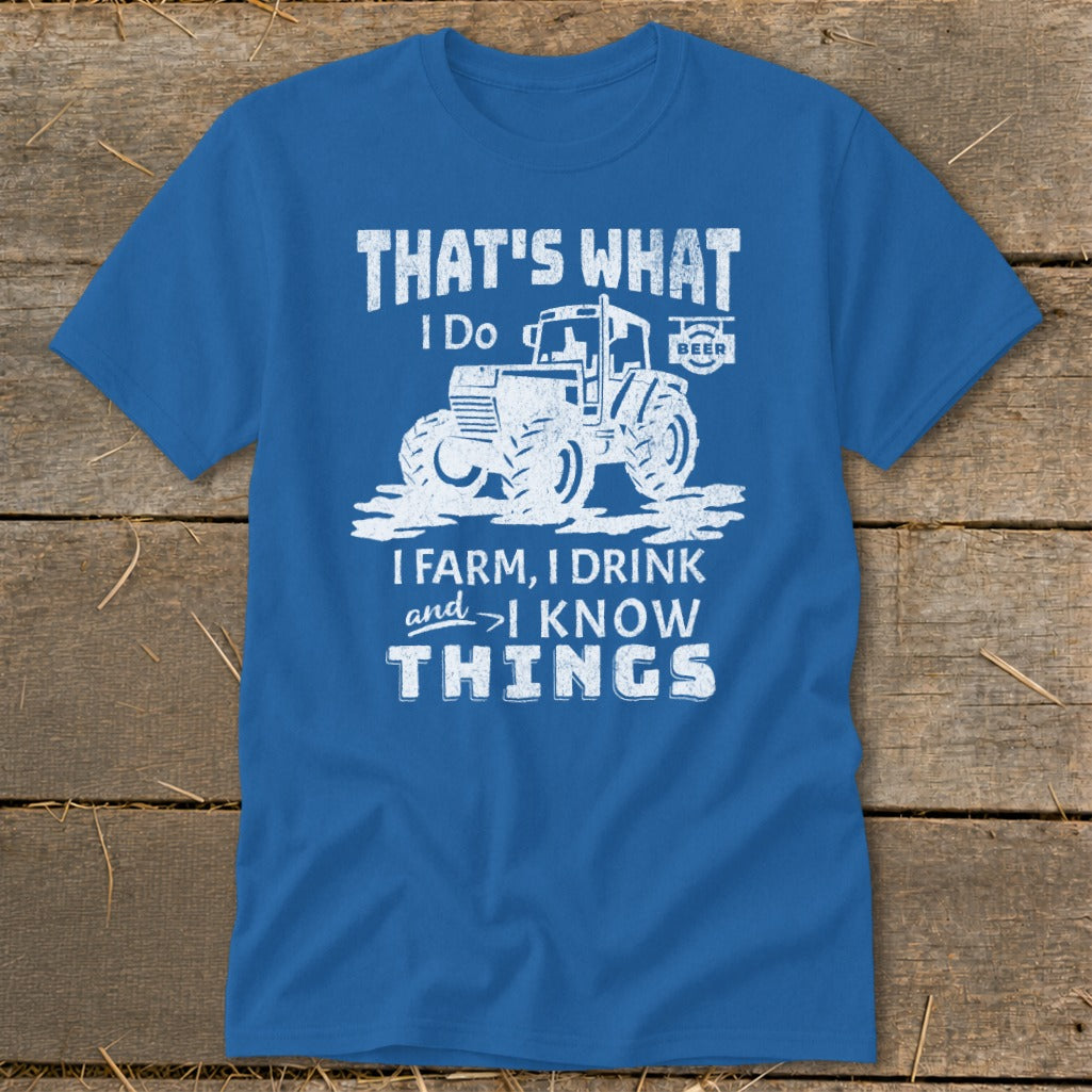 Blue t-shirt with white text and tractor graphic: "That's What I Do. I Farm, I Drink and I Know Things."