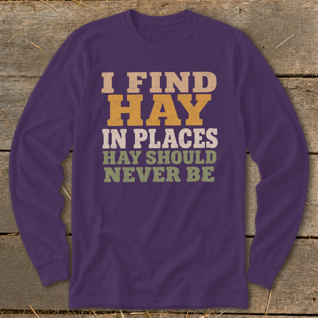 Purple long sleeve shirt with text "I FIND HAY IN PLACES HAY SHOULD NEVER BE".
