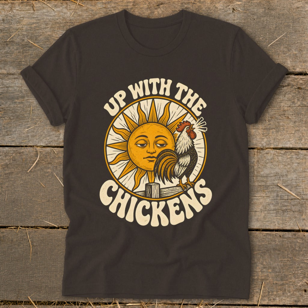 Dark brown t-shirt featuring a retro graphic of a crowing rooster, sun, and text reading Up With The Chickens.