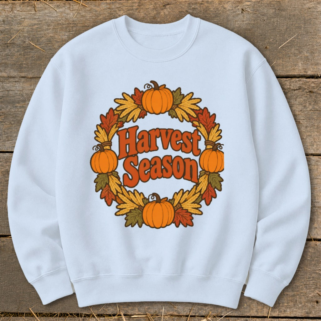 Light blue crewneck sweatshirt with a rustic "Harvest Season" graphic featuring pumpkins and fall leaves.