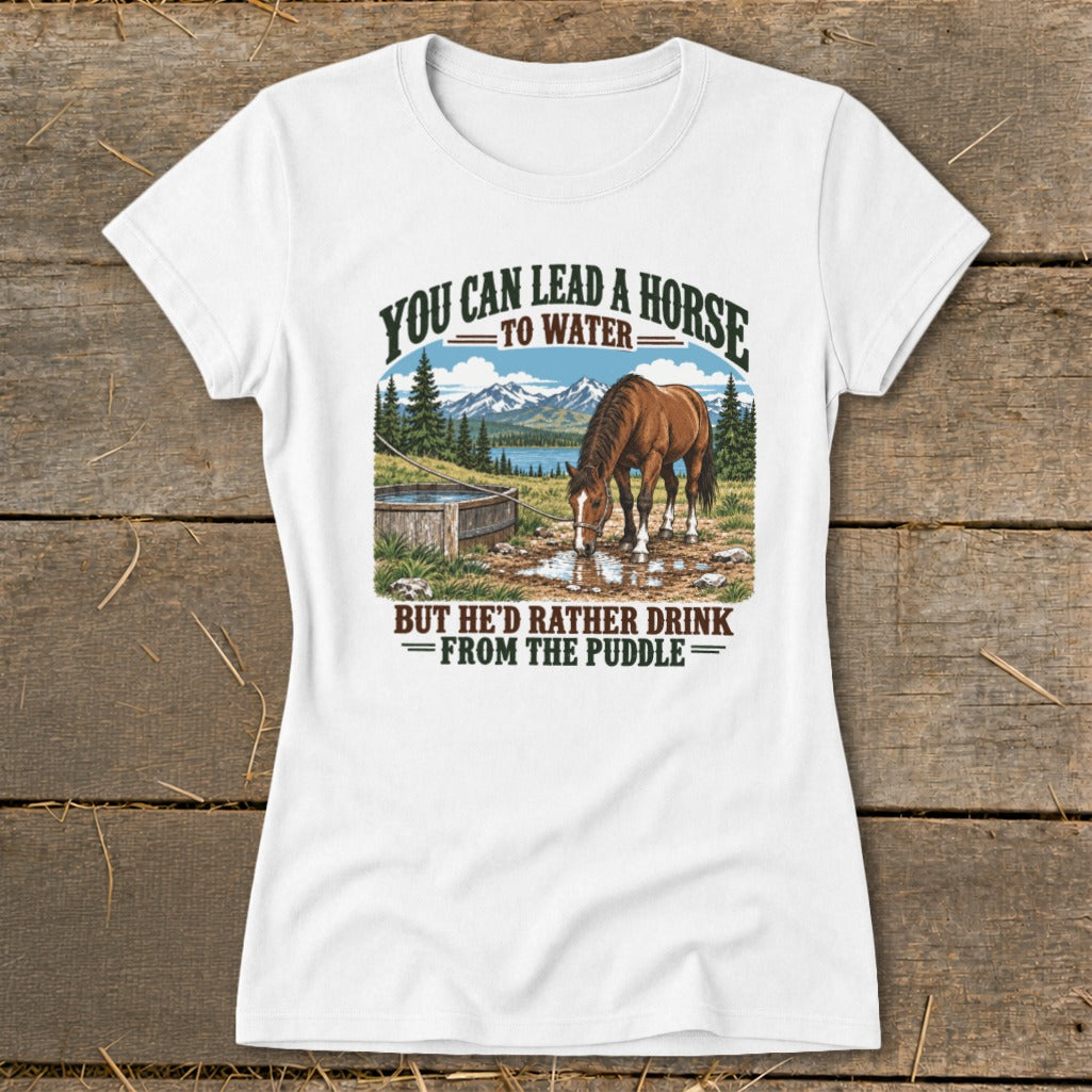 A white t-shirt featuring a graphic illustration of a horse drinking from a puddle with humorous text.