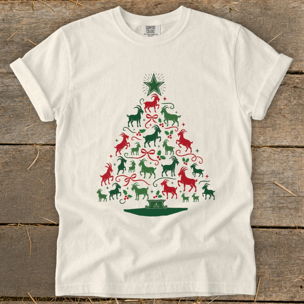 White t-shirt with a Christmas tree made of red and green goats and holly.
