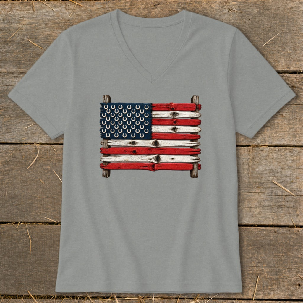 A grey V-neck t-shirt featuring a rustic American flag graphic made of painted wooden planks and horseshoes.