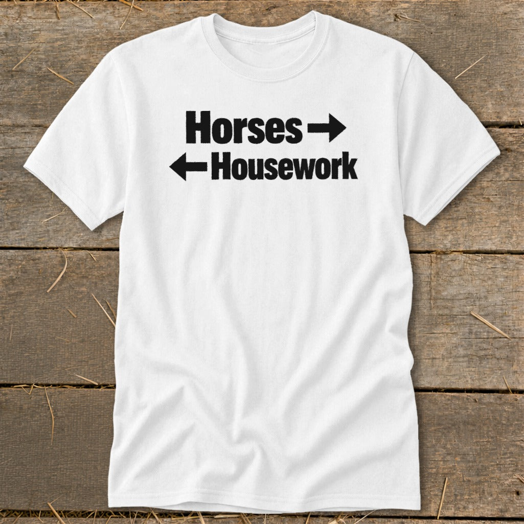 A white t-shirt with black text reading "Horses" pointing right and "Housework" pointing left.