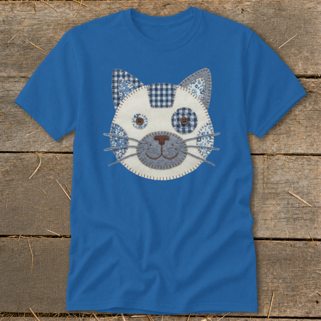 Blue t-shirt with a stitched cat face applique in blue and white fabrics.