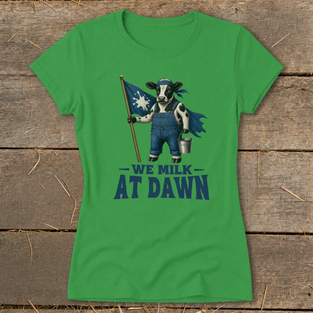 Green t-shirt with a cow holding a flag and pail, text reads "We Milk At Dawn."