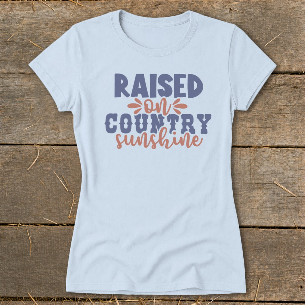 Light blue t-shirt with "Raised on Country Sunshine" text.