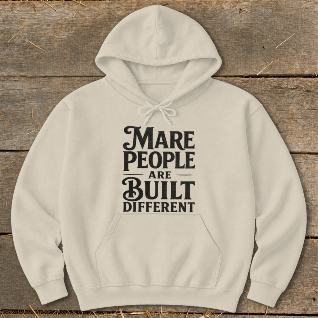 Cream hoodie with black text that reads "Mare People Are Built Different".