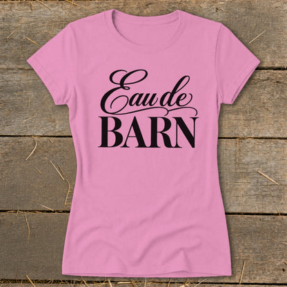 Pink t-shirt with "Eau de BARN" text in black cursive and block letters.