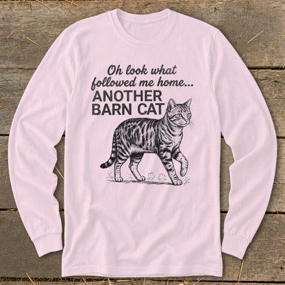 Long sleeve pink shirt with a drawing of a tabby cat and the text "Oh look what followed me home... ANOTHER BARN CAT".