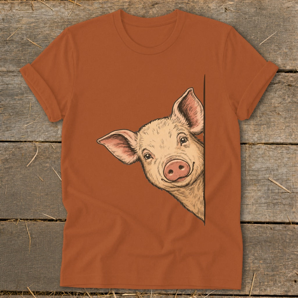 Illustration of a pig peeking around a corner on an orange t-shirt.