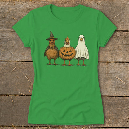 Three chickens dressed in Halloween costumes: witch, pumpkin, and ghost.