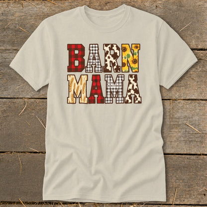 Light-colored t-shirt with "BARN MAMA" text in buffalo plaid, cow print, sunflowers, and wheat.