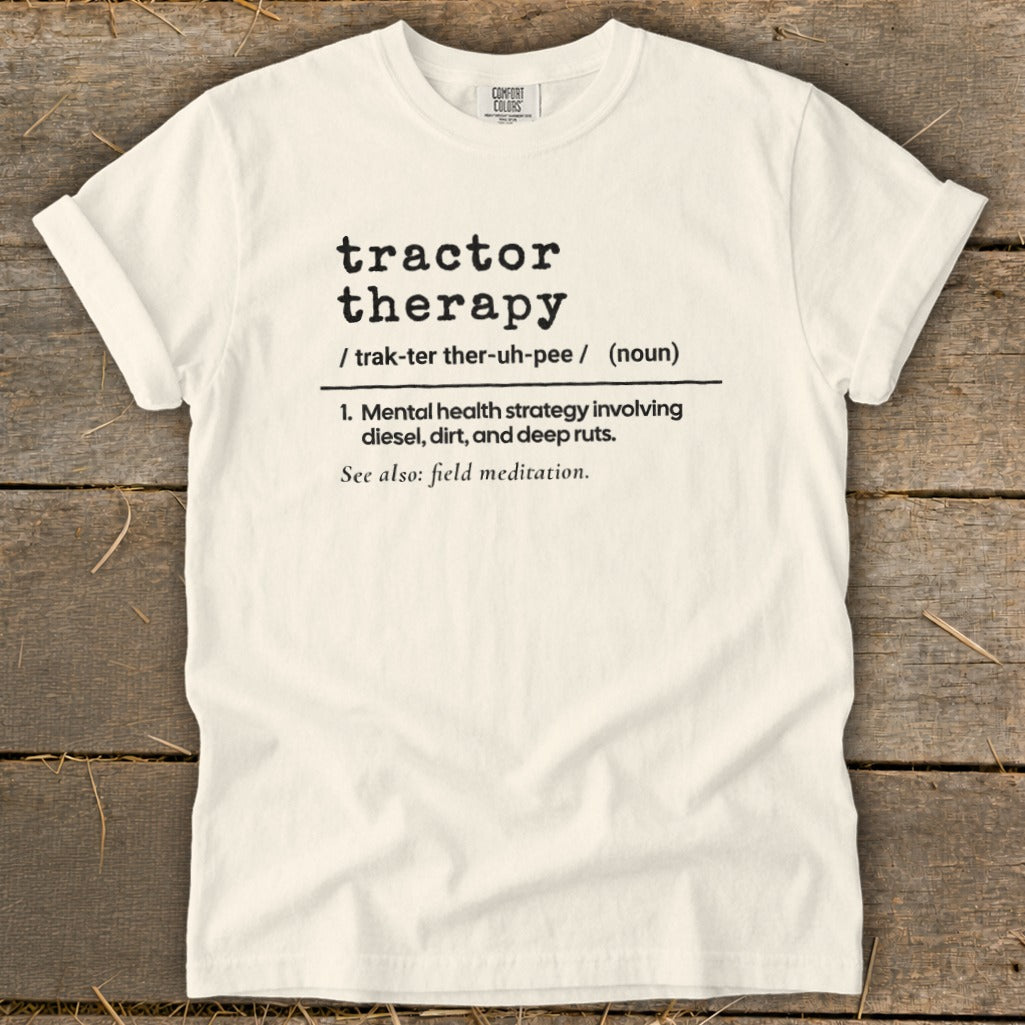 Cream Comfort Colors t-shirt with "tractor therapy" definition in black text.