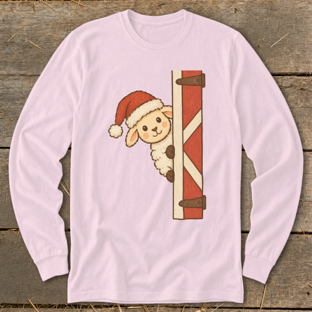 Pink long-sleeve shirt with a cartoon sheep wearing a Santa hat peeking from a barn door.