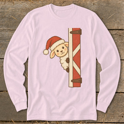Pink long-sleeve shirt with a cartoon sheep wearing a Santa hat peeking from a barn door.