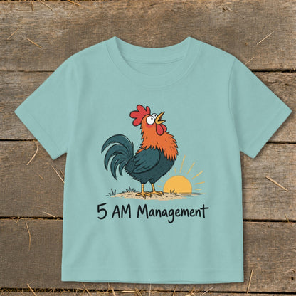 Light blue t-shirt with a cartoon rooster and sunrise, says "5 AM Management".