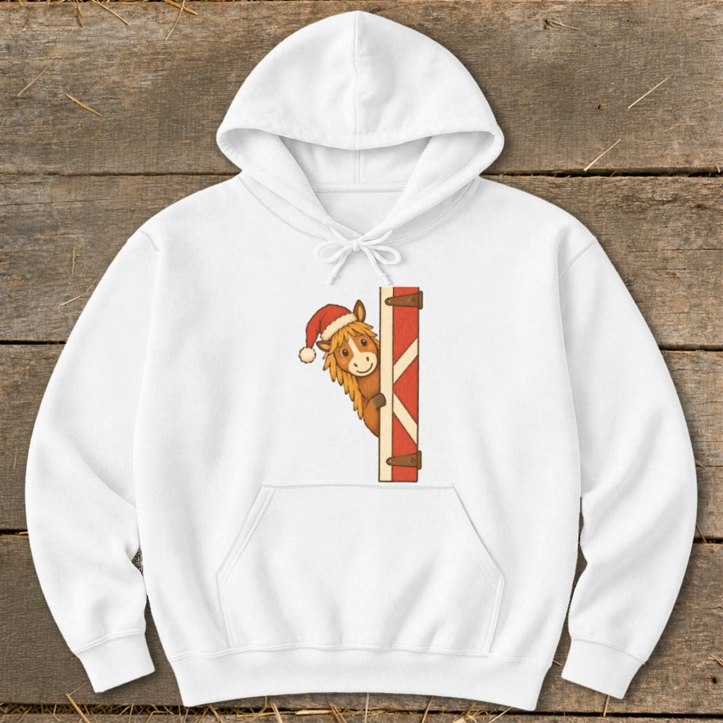 White hoodie with a cartoon horse wearing a Santa hat peeking from behind a red barn door.