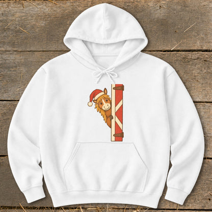 White hoodie with a cartoon horse wearing a Santa hat peeking from behind a red barn door.