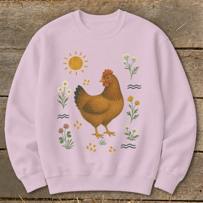 Light pink sweatshirt with a brown hen surrounded by flowers, sun, and water waves.