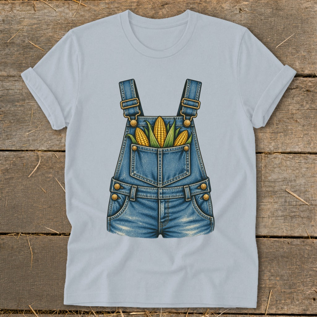 Light blue t-shirt with a graphic of denim overalls and three ears of corn in the pocket.