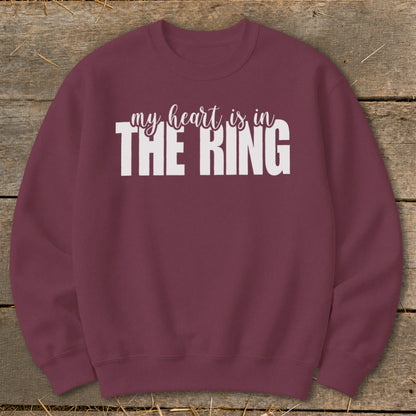 Maroon sweatshirt with white text "my heart is in THE RING".