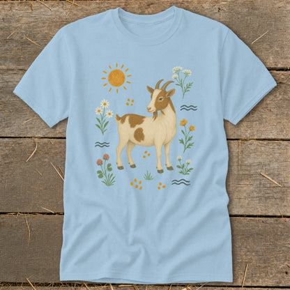 Light blue t-shirt with a brown and white goat surrounded by flowers, sun, and wavy lines.