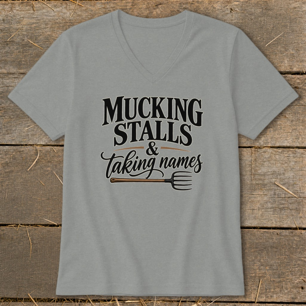 Grey v-neck t-shirt with text "Mucking Stalls & Taking Names" and a pitchfork.