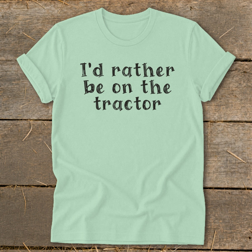 Light green t-shirt with "I'd rather be on the tractor" printed in black lettering.