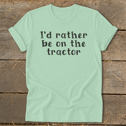 Light green t-shirt with "I'd rather be on the tractor" printed in black lettering.