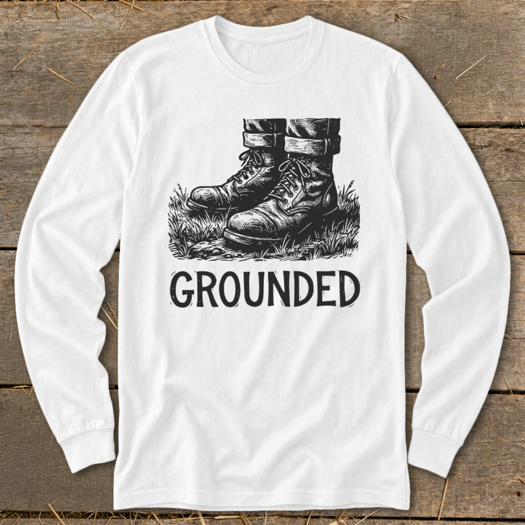 White long-sleeve shirt with black graphic of boots in grass and text "GROUNDED".