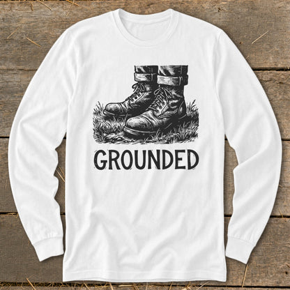 White long-sleeve shirt with black graphic of boots in grass and text "GROUNDED".