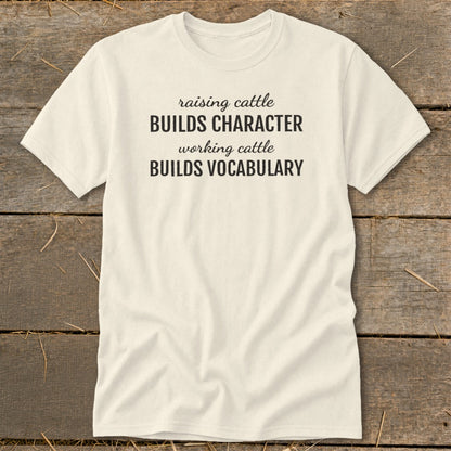 Cream t-shirt with text "raising cattle BUILDS CHARACTER working cattle BUILDS VOCABULARY".