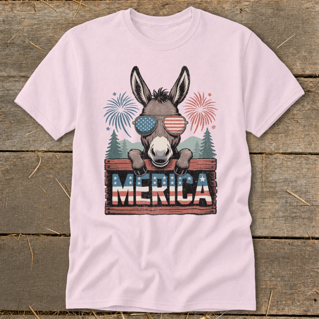 Donkey wearing American flag sunglasses and holding "Merica" sign with fireworks.