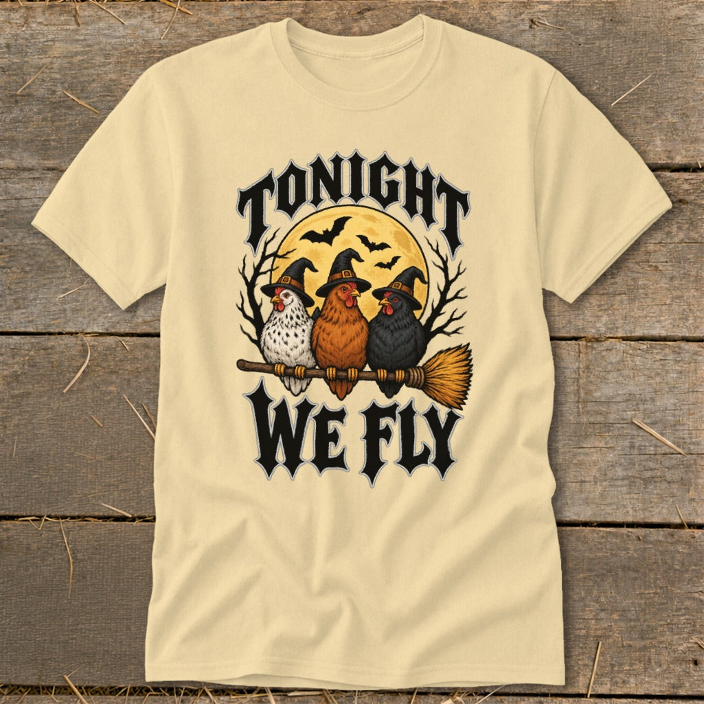 Three chickens in witch hats ride a broomstick under a full moon with text "Tonight We Fly".