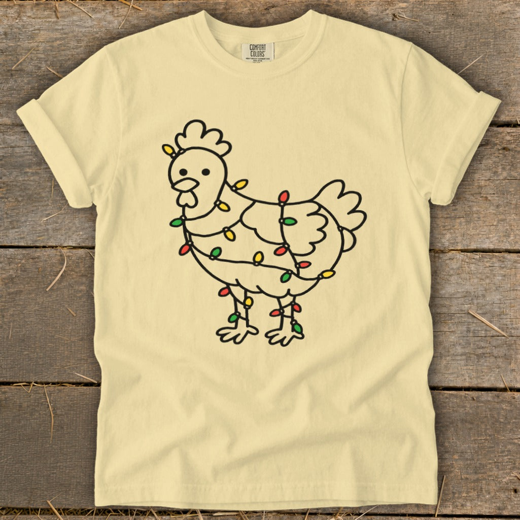 Line art chicken wrapped in colorful Christmas lights on a pale yellow t-shirt.