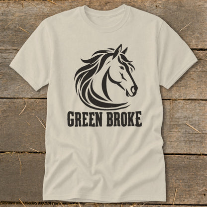 A cream-colored short-sleeved t-shirt featuring a black horse head graphic and the text GREEN BROKE.