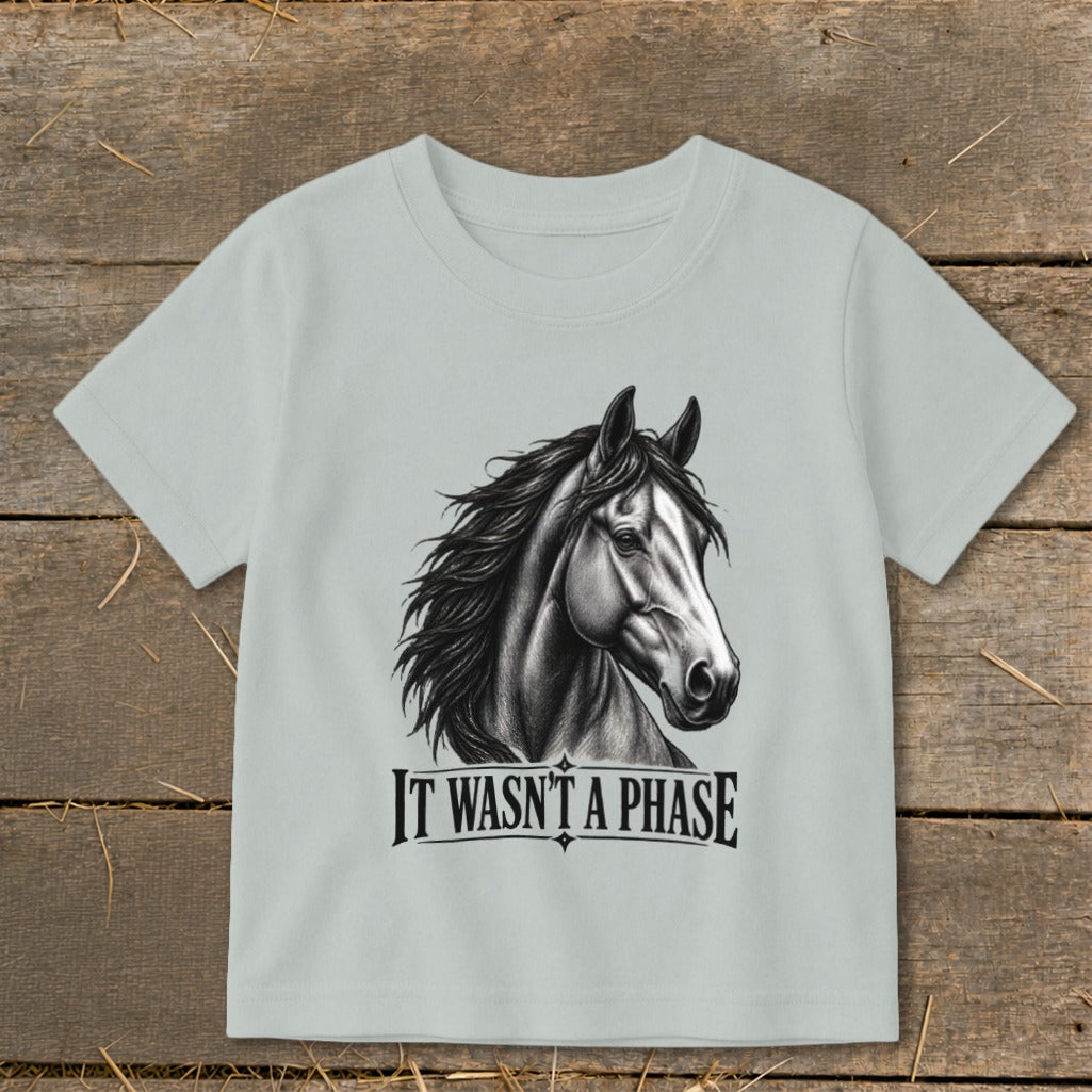 Light blue t-shirt with a charcoal sketch of a horse's head and the text "IT WASN'T A PHASE".