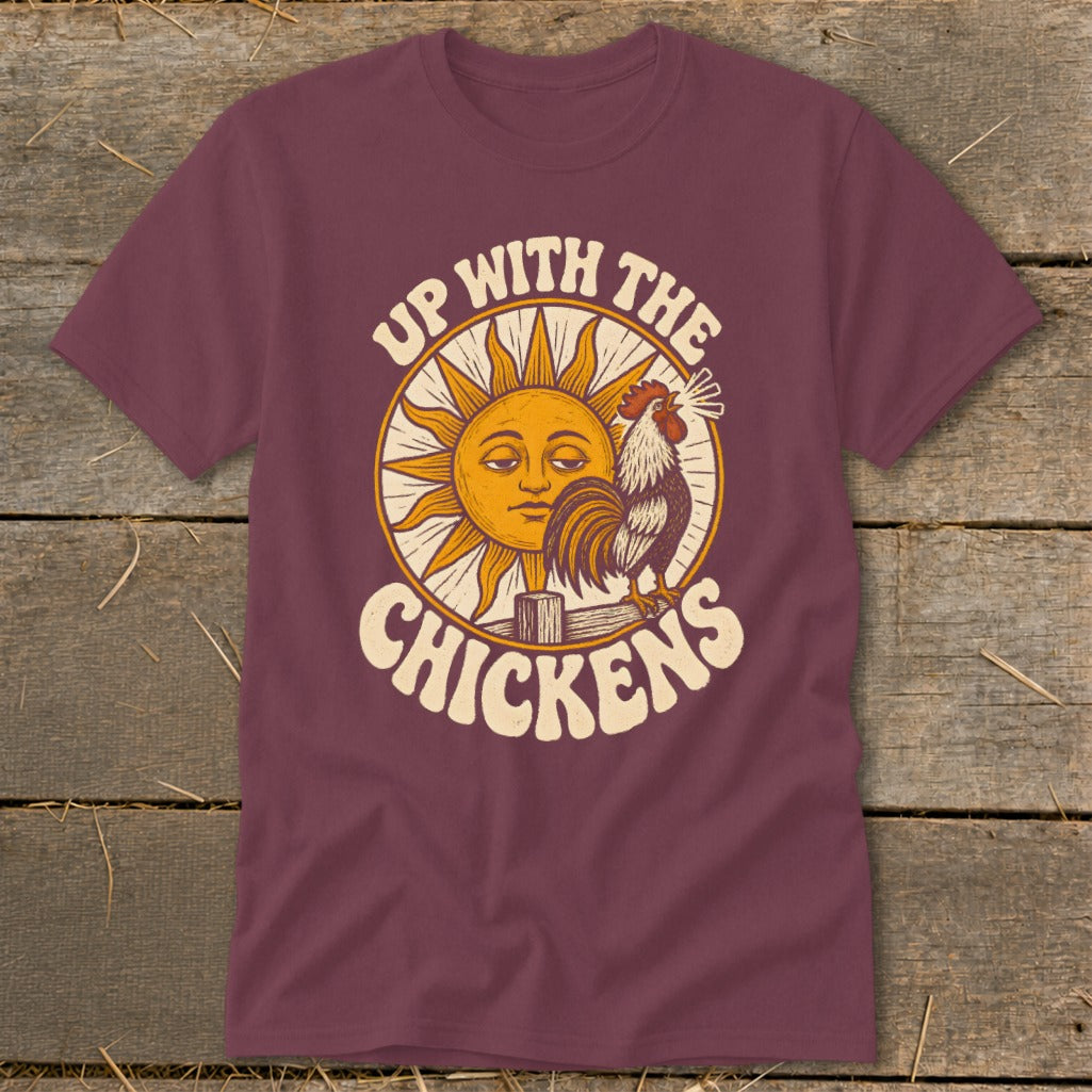 Maroon t-shirt featuring a retro graphic of a sun, rooster, and the text Up With The Chickens.