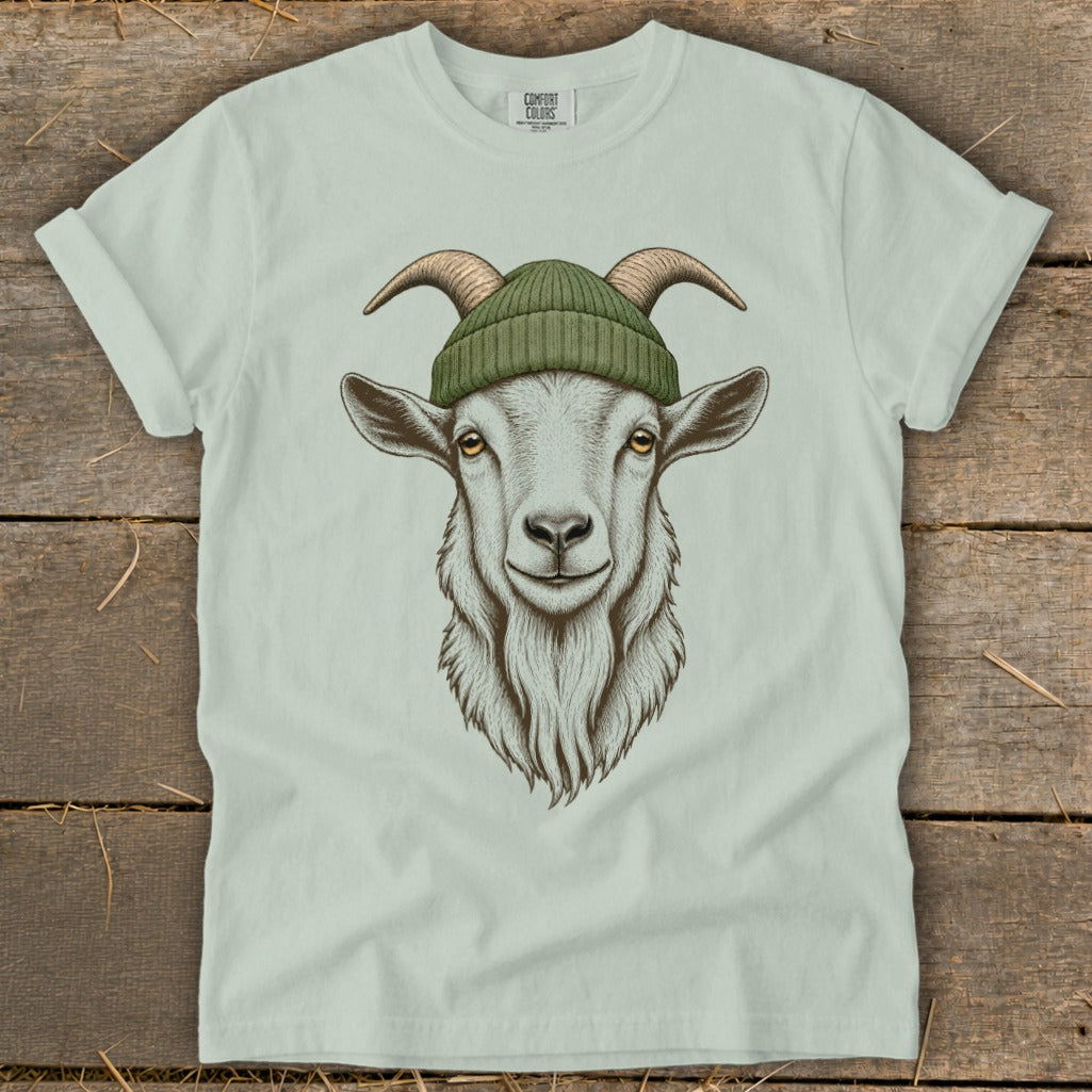 White t-shirt with illustration of a goat wearing a green beanie.