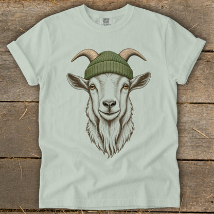 White t-shirt with illustration of a goat wearing a green beanie.