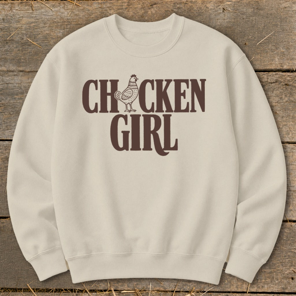Cream sweatshirt with dark brown "CHICKEN GIRL" text and chicken graphic.