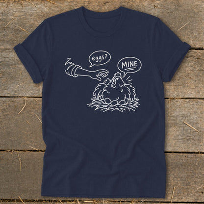T-shirt graphic with chicken on eggs and hand asking "eggs?" with "MINE" speech bubble.